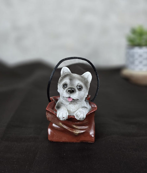1 pc Cute Miniature Dog in Bag Poly Resin Statue with Hanging, Decorative Piece for Living Room, Bed Room, Table top, Restaurant, cafes, Gifting, Birthday( Pack of 1)